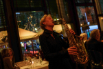 Eva playing saxophone at a dinner event