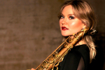 Saxophonist Tallulah Rose posing with a saxophone