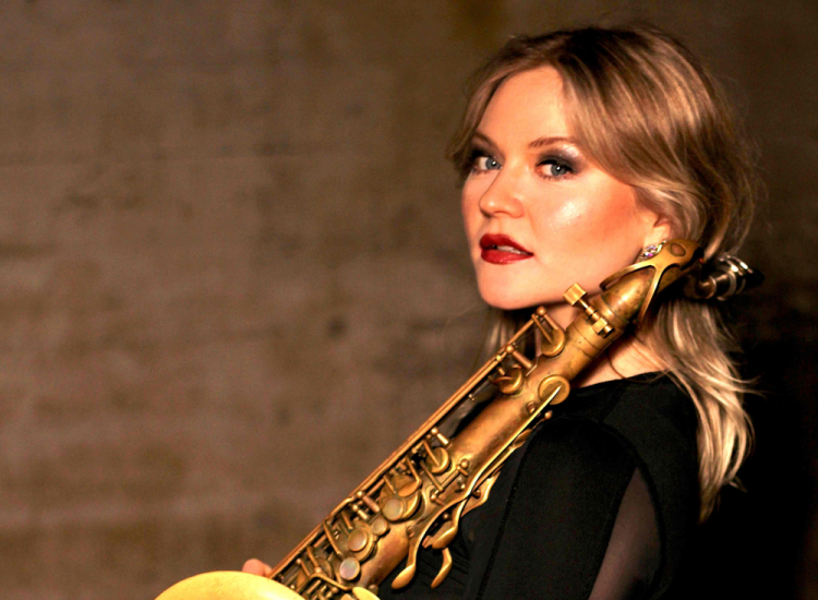 Saxophonist Tallulah Rose posing with a saxophone